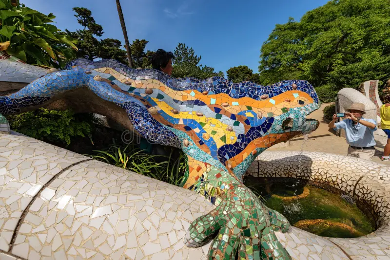 A tourist taking a photo of Gaudí’s dragon